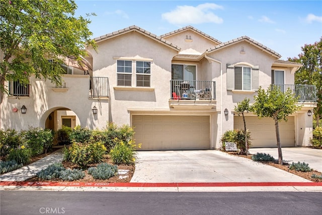 36287 Grazia Way, Winchester, CA 92596 - mediterranean / spanish home featuring a balcony, stucco siding, a garage, and concrete driveway