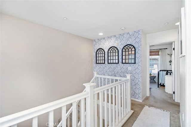36287 Grazia Way, Winchester, CA 92596 - hallway featuring an accent wall, an upstairs landing, wallpapered walls, recessed lighting, and light colored carpet