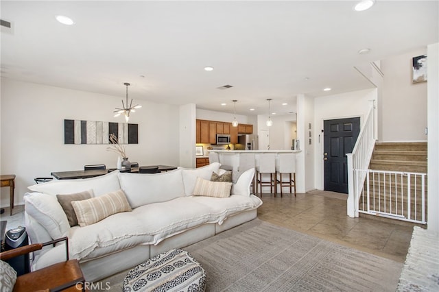 36287 Grazia Way, Winchester, CA 92596 - living area with stairs, a chandelier, recessed lighting, and light tile patterned floors
