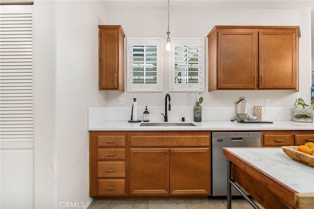 36287 Grazia Way, Winchester, CA 92596 - kitchen with dishwasher, brown cabinetry, light countertops, and hanging light fixtures