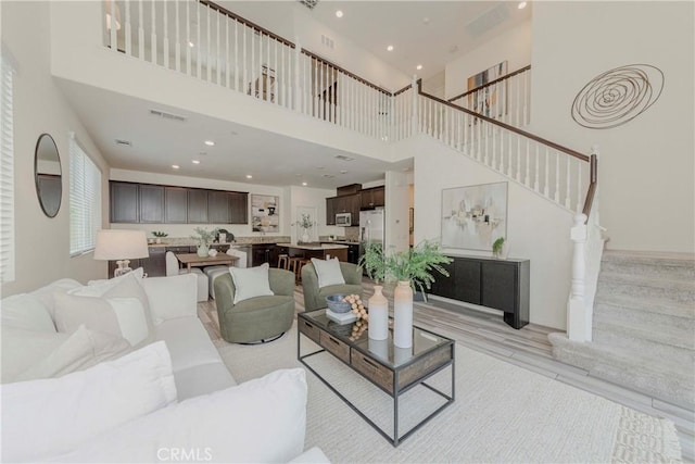 8708 Celebration St, Chino, CA 91708 - living room with stairway, a high ceiling, and recessed lighting