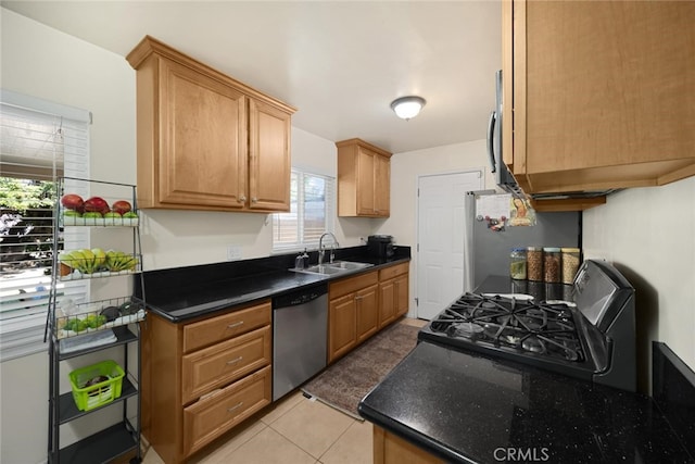 1344 S Douglas St, Santa Ana, CA 92704 - kitchen featuring appliances with stainless steel finishes, dark countertops, and light tile patterned floors