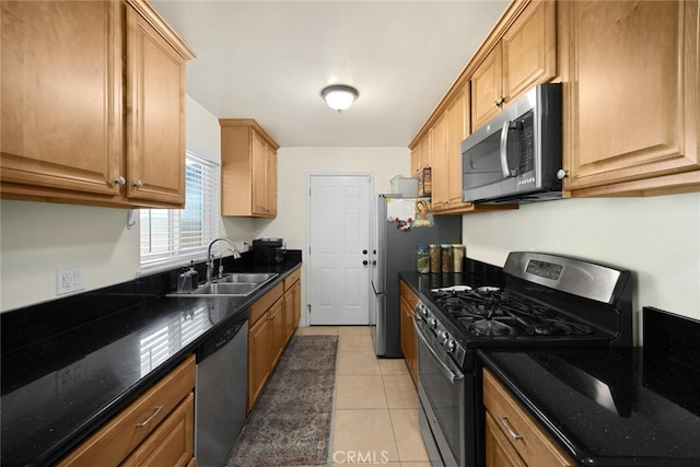 1344 S Douglas St, Santa Ana, CA 92704 - kitchen featuring stainless steel appliances, dark stone counters, and light tile patterned floors