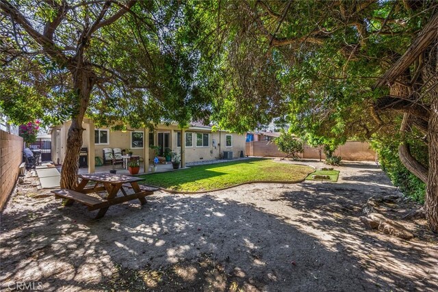 1344 S Douglas St, Santa Ana, CA 92704 - back of property with a fenced backyard, a patio, and stucco siding