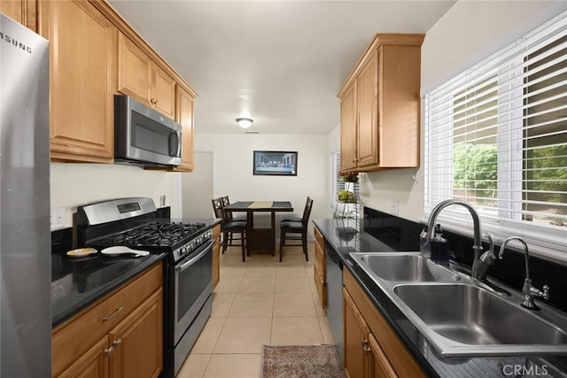 1344 S Douglas St, Santa Ana, CA 92704 - kitchen featuring appliances with stainless steel finishes, dark countertops, and light tile patterned flooring