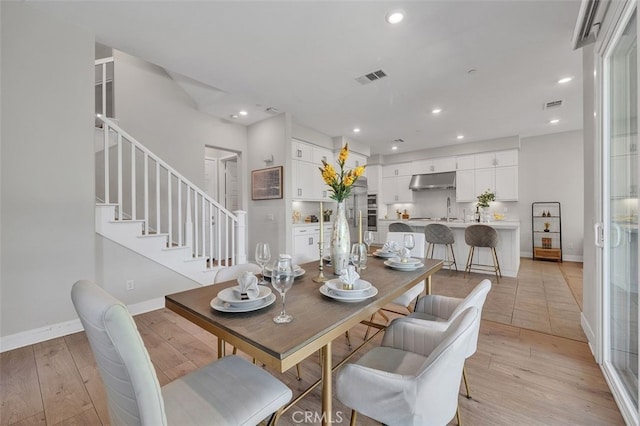 319 Sawbuck, Irvine, CA 92618 - dining room with light wood-type flooring, recessed lighting, and stairs