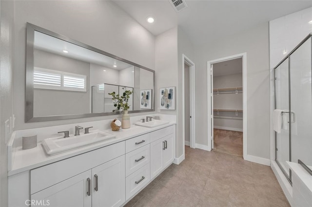319 Sawbuck, Irvine, CA 92618 - full bathroom with a shower stall, double vanity, a spacious closet, recessed lighting, and tile patterned floors
