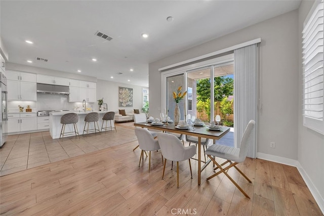 319 Sawbuck, Irvine, CA 92618 - dining room with light wood finished floors and recessed lighting