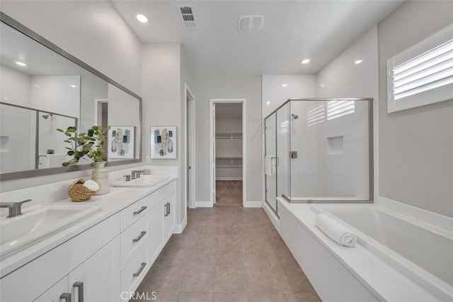 319 Sawbuck, Irvine, CA 92618 - full bath featuring a stall shower, double vanity, a garden tub, a walk in closet, and tile patterned floors