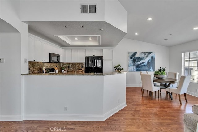 3434 E Lambeth Ct Unit F, Orange, CA 92869 - kitchen with black appliances, dark stone counters, white cabinetry, backsplash, and wood finished floors