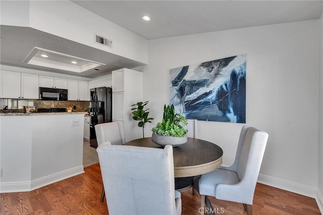 3434 E Lambeth Ct Unit F, Orange, CA 92869 - dining space with wood finished floors and recessed lighting