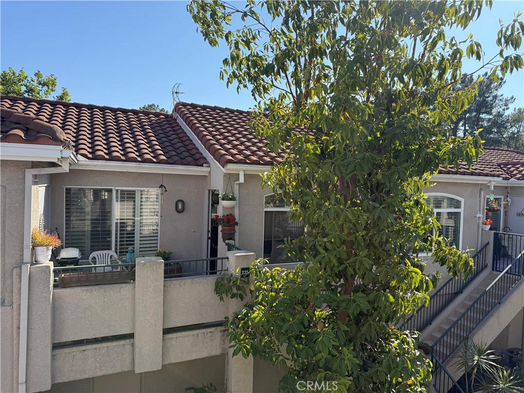 225 Cinnamon Teal, Aliso Viejo, CA 92656 - mediterranean / spanish house with stucco siding, a tiled roof, and a balcony