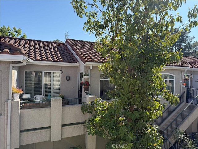 225 Cinnamon Teal, Aliso Viejo, CA 92656 - mediterranean / spanish house with stucco siding, a tiled roof, and a balcony