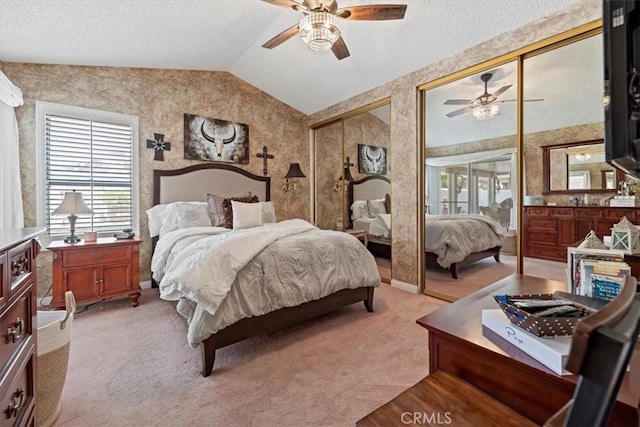 5129 W Pinehurst Dr, Banning, CA 92220 - bedroom featuring lofted ceiling, wallpapered walls, two closets, light colored carpet, and a ceiling fan