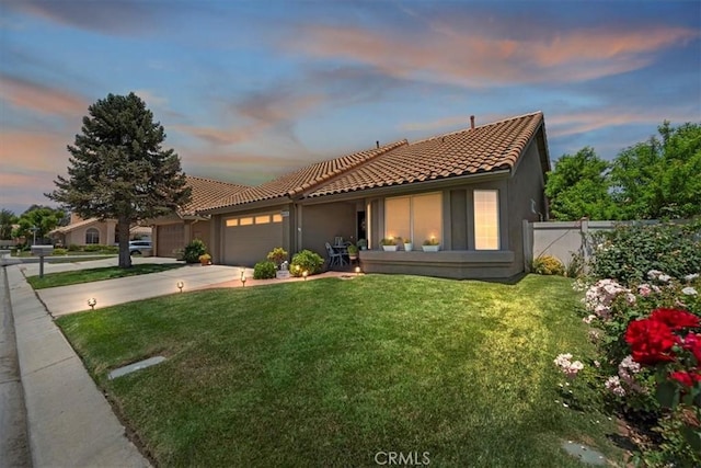 5129 W Pinehurst Dr, Banning, CA 92220 - mediterranean / spanish-style house featuring an attached garage, driveway, a tile roof, and stucco siding