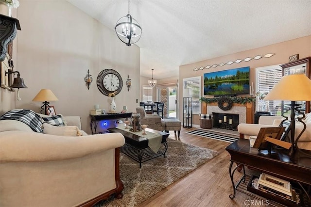 5129 W Pinehurst Dr, Banning, CA 92220 - living area with a chandelier, wood finished floors, a textured ceiling, and a high end fireplace