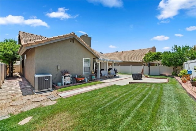 5129 W Pinehurst Dr, Banning, CA 92220 - rear view of house with a patio, a chimney, stucco siding, and a fenced backyard