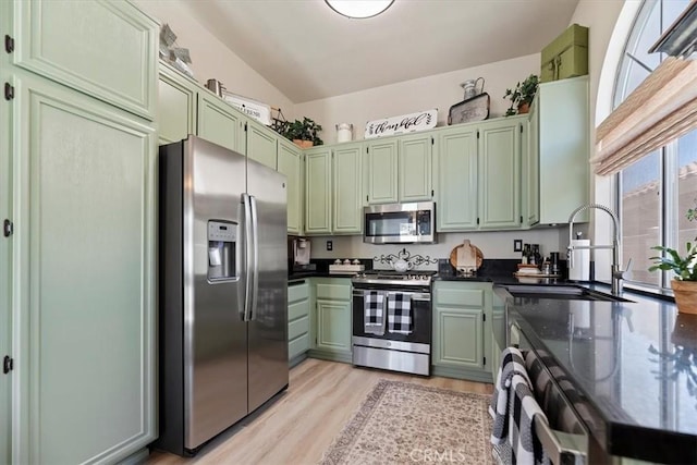 5129 W Pinehurst Dr, Banning, CA 92220 - kitchen featuring appliances with stainless steel finishes, green cabinetry, light wood-style floors, and dark stone countertops