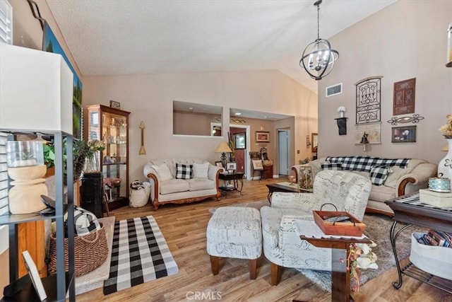 5129 W Pinehurst Dr, Banning, CA 92220 - living area featuring wood finished floors, a chandelier, and high vaulted ceiling