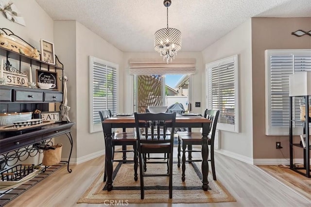 5129 W Pinehurst Dr, Banning, CA 92220 - dining room with a textured ceiling, wood finished floors, healthy amount of natural light, and a chandelier