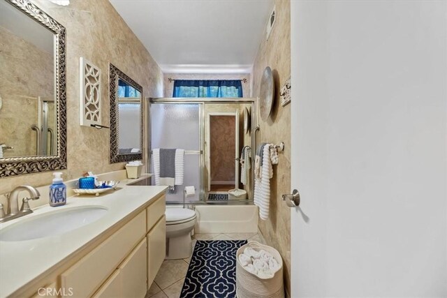 5129 W Pinehurst Dr, Banning, CA 92220 - full bathroom featuring vanity, bath / shower combo with glass door, and tile patterned flooring