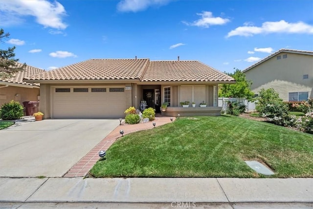 5129 W Pinehurst Dr, Banning, CA 92220 - view of front of property featuring a tile roof, an attached garage, a front yard, and stucco siding
