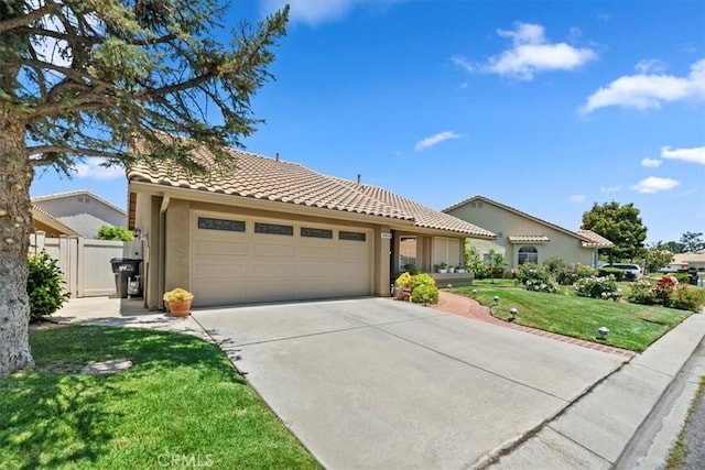 5129 W Pinehurst Dr, Banning, CA 92220 - view of front of home with driveway, an attached garage, a tile roof, and stucco siding