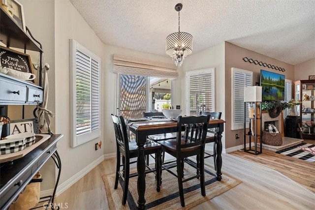 5129 W Pinehurst Dr, Banning, CA 92220 - dining area featuring a chandelier, a textured ceiling, and wood finished floors