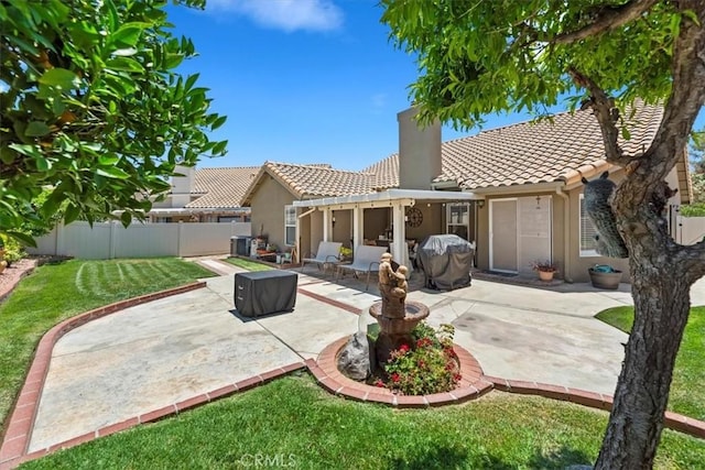 5129 W Pinehurst Dr, Banning, CA 92220 - back of house with a tiled roof, stucco siding, a fenced backyard, and a patio