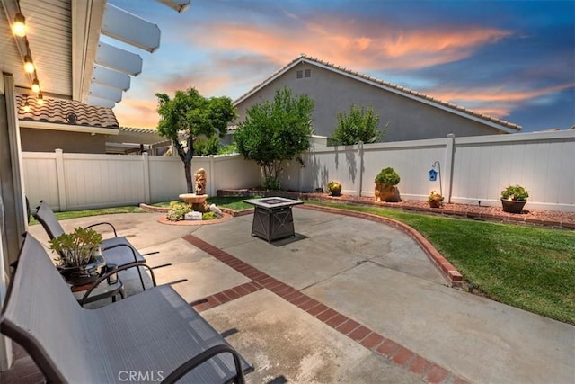 5129 W Pinehurst Dr, Banning, CA 92220 - patio terrace at dusk featuring a patio area, an outdoor fire pit, and a fenced backyard