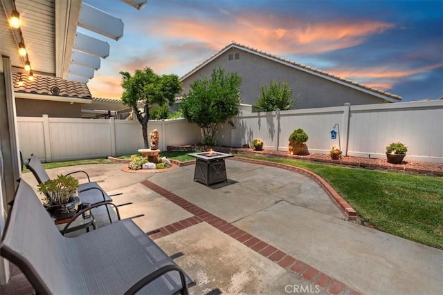 5129 W Pinehurst Dr, Banning, CA 92220 - patio terrace at dusk featuring a fire pit, a patio area, and a fenced backyard