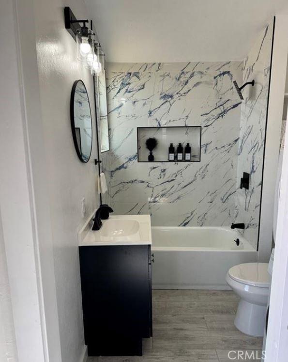 55354 El Lobo Rd, Landers, CA 92285 - full bathroom featuring vanity, shower / bathtub combination, and wood finished floors