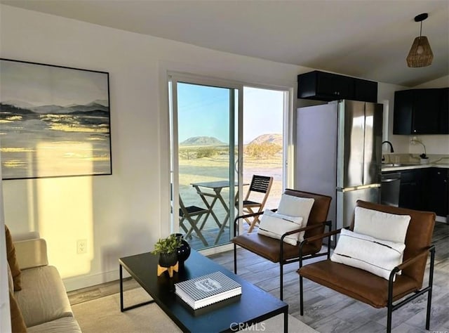 55354 El Lobo Rd, Landers, CA 92285 - living area with a mountain view, light wood-type flooring, and vaulted ceiling