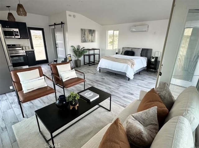 55354 El Lobo Rd, Landers, CA 92285 - bedroom with a wall mounted air conditioner, vaulted ceiling, light wood-style flooring, and a barn door