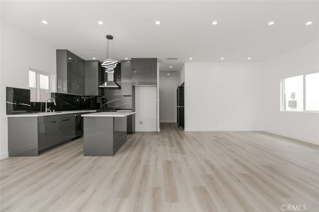 15009 Wyandotte St, Van Nuys, CA 91405 - kitchen featuring modern cabinets, gray cabinets, a kitchen island, wall chimney exhaust hood, and recessed lighting