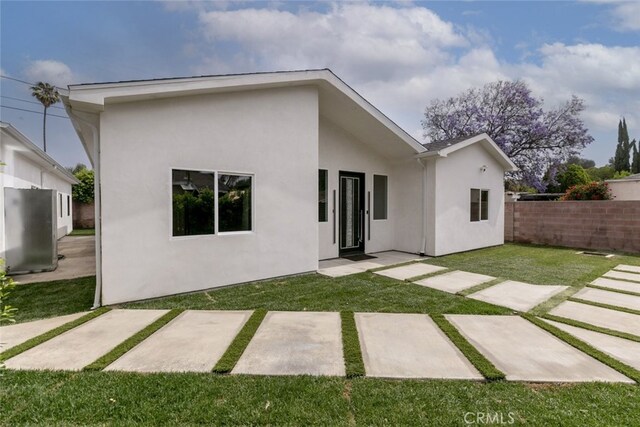 15009 Wyandotte St, Van Nuys, CA 91405 - rear view of house featuring stucco siding and a patio area