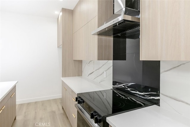 15009 Wyandotte St, Van Nuys, CA 91405 - kitchen with modern cabinets, light brown cabinetry, wall chimney exhaust hood, and recessed lighting