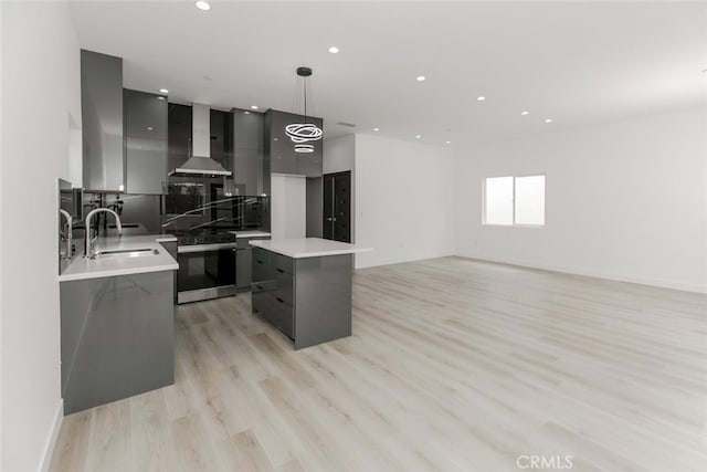15009 Wyandotte St, Van Nuys, CA 91405 - kitchen with modern cabinets, wall chimney range hood, gas stove, gray cabinetry, and a kitchen island