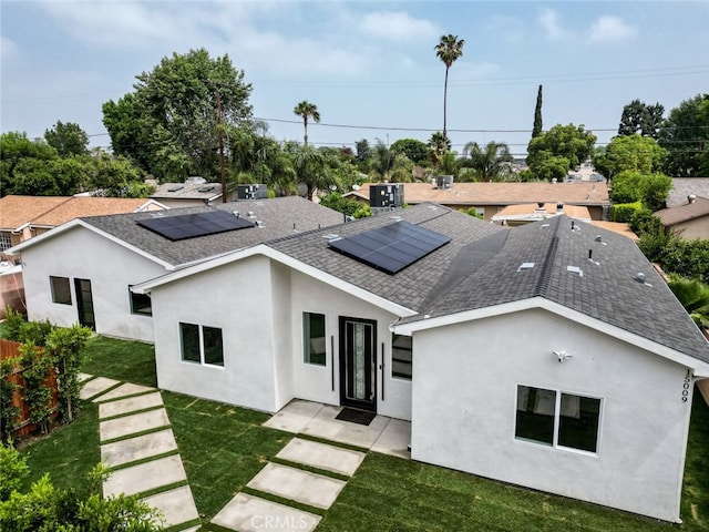 15009 Wyandotte St, Van Nuys, CA 91405 - back of property featuring a shingled roof, stucco siding, and roof mounted solar panels