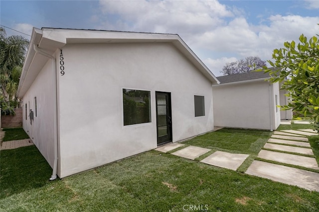 15009 Wyandotte St, Van Nuys, CA 91405 - back of house featuring stucco siding and a lawn