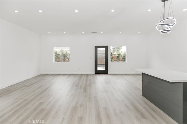 15009 Wyandotte St, Van Nuys, CA 91405 - unfurnished living room with healthy amount of natural light, recessed lighting, and light wood-style floors
