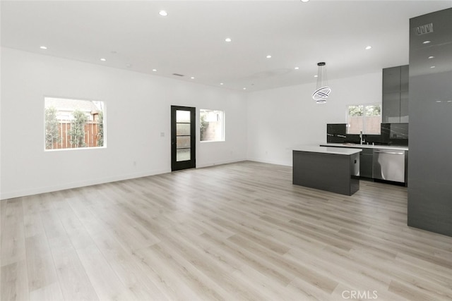 15009 Wyandotte St, Van Nuys, CA 91405 - unfurnished living room with recessed lighting, healthy amount of natural light, and light wood-style flooring