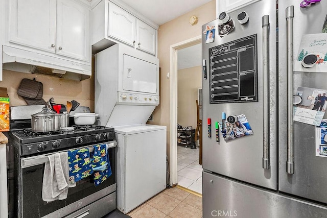 23277 Maribel Ave, Carson, CA 90745 - kitchen with gas stove, fridge, stacked washing machine and dryer, under cabinet range hood, and white cabinetry