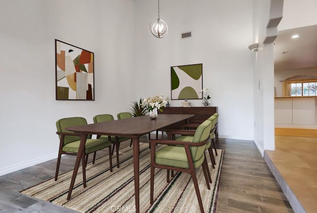 9733 Kentland Ave, Chatsworth, CA 91311 - dining room with wood finished floors, a towering ceiling, and a chandelier