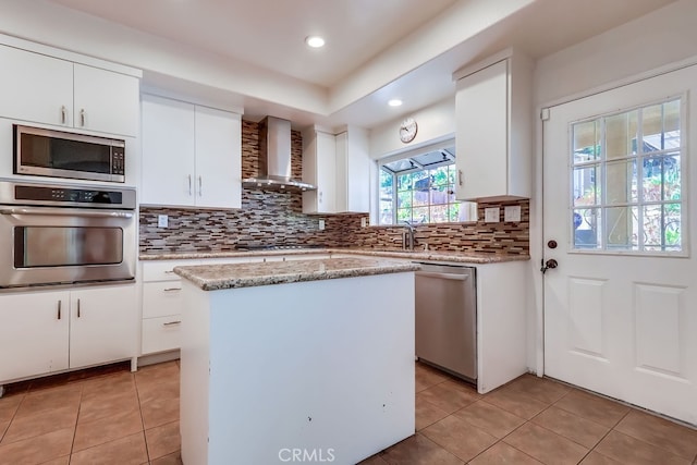 9733 Kentland Ave, Chatsworth, CA 91311 - kitchen with appliances with stainless steel finishes, wall chimney exhaust hood, light tile patterned floors, backsplash, and recessed lighting