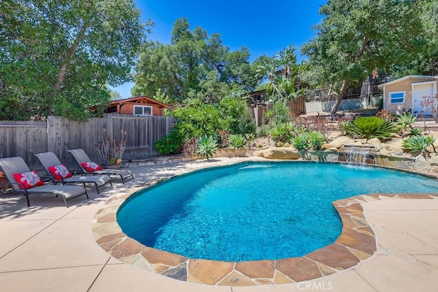 9733 Kentland Ave, Chatsworth, CA 91311 - view of pool featuring a patio area, a fenced backyard, and a storage shed