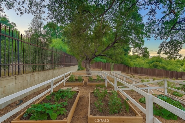 9733 Kentland Ave, Chatsworth, CA 91311 - yard at dusk featuring a garden and a fenced backyard