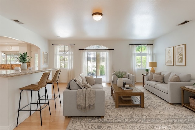 9733 Kentland Ave, Chatsworth, CA 91311 - living room with arched walkways and light wood-type flooring