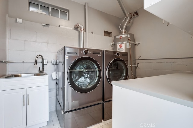 9733 Kentland Ave, Chatsworth, CA 91311 - washroom with washing machine and dryer, strapped water heater, cabinet space, light tile patterned flooring, and tile walls