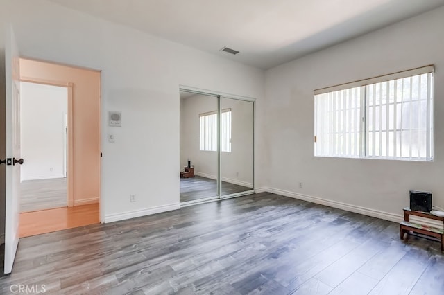 9733 Kentland Ave, Chatsworth, CA 91311 - unfurnished bedroom with wood finished floors and a closet
